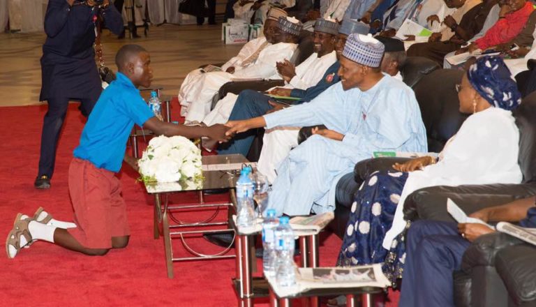 Benue school boy shakes Buhari in Aso rock on his knees (Photos)