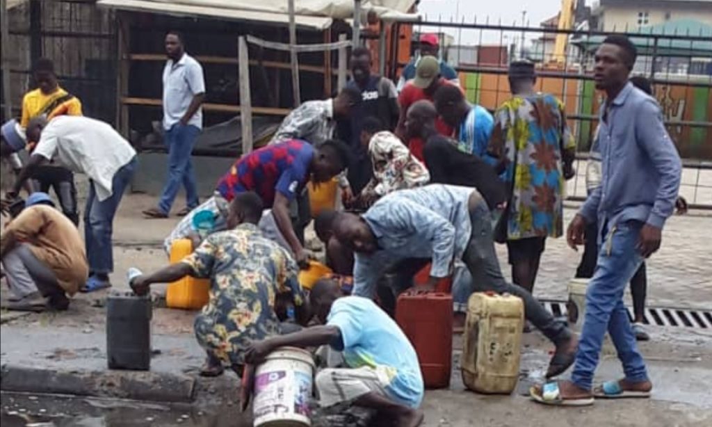 DANGER: Residents scoop fuel as petrol tanker falls in Lagos