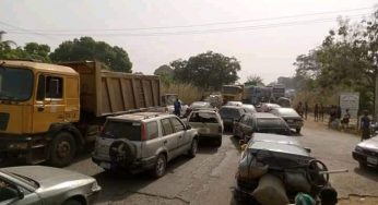 Heavy duty truck drivers block major highway in protest against illegal tax collectors