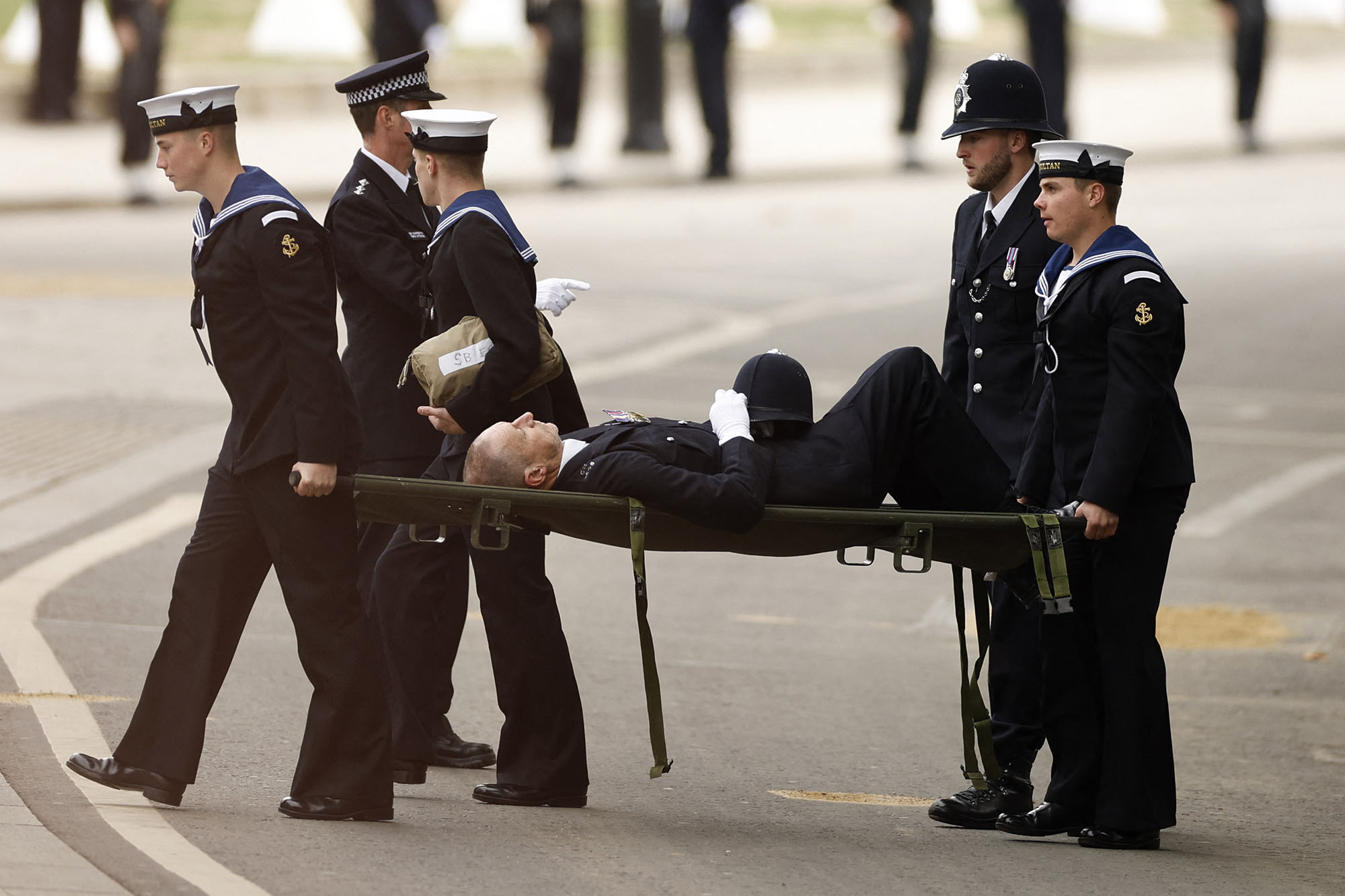 Policeman collapses, carried on stretcher at Queen's funeral